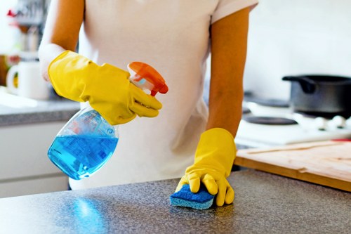 Staff member using cleaning equipment with safety awareness