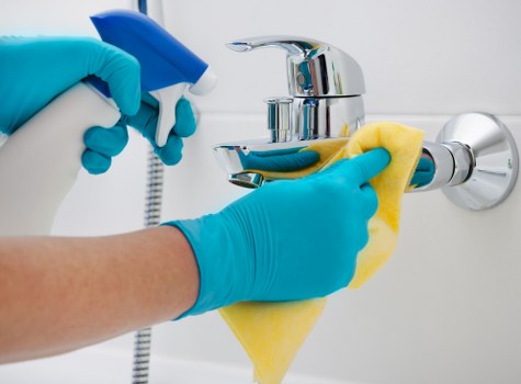 Cleaner wearing PPE while carrying out professional cleaning in Barnes